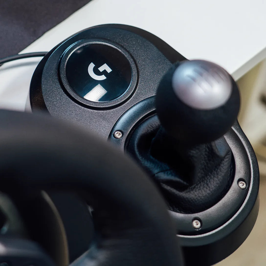 Logitech Driving Force Shifter designed for G29 and G920 racing wheels, featuring a durable steel and leather build with a six-speed H-pattern gearbox for a realistic driving experience.