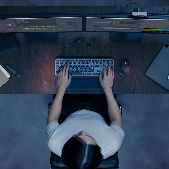 Logitech MX Keys S Wireless Keyboard in graphite used on a modern desk setup for professional work or content creation