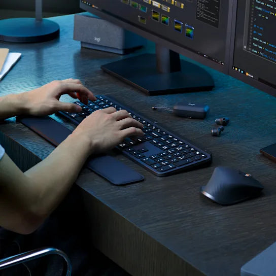 Logitech MX Keys S Wireless Keyboard in graphite used on a modern desk setup for professional work or content creation